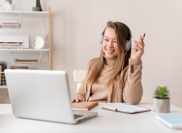 Free photo portrait female at work having video call