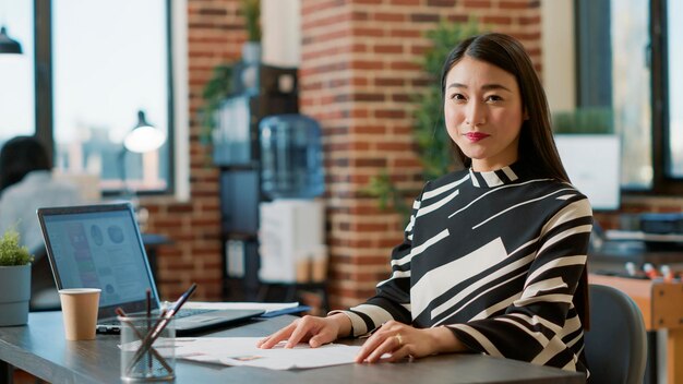 Portrait of female worker using recruitment papers to start job interview with candidates, finding person to hire for executive business work. HR employee looking at cv for career experience.