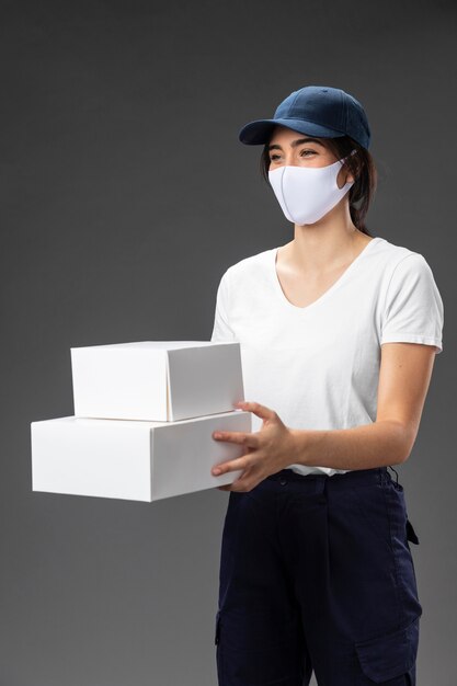 Portrait female working for delivery service wearing mask