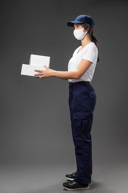 Portrait female working for delivery service wearing mask