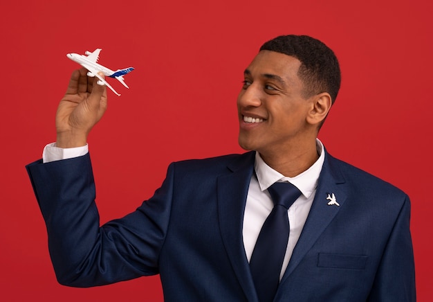 Free photo portrait of flight attendant with plane figurine