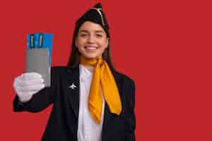 Free photo portrait of flight attendant with plane tickets and passport