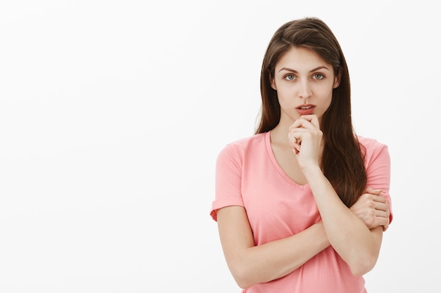 Portrait of focused brunette woman posing in the studio