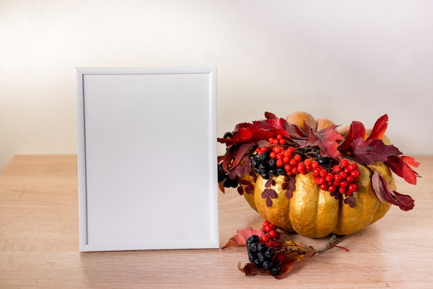 Portrait frame mock up with pumpkin on wooden table. halloween . high quality photo