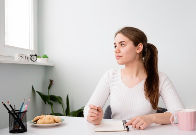 Portrait freelance woman working at home in agenda
