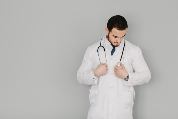 Portrait of a friendly doctor Isolated on gray