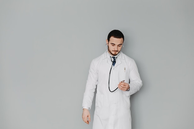 Portrait of a friendly doctor Isolated on gray