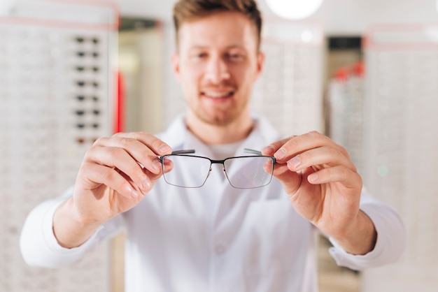 Portrait of friendly male optometrist