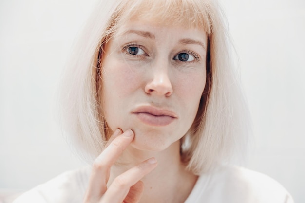 Portrait of a frustrated woman on a white background