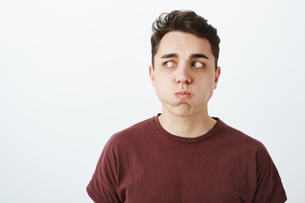 Portrait of funny european male model in red t-shirt