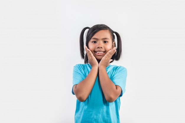 Portrait of Funny little girl acting in studio shot