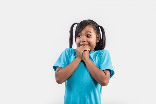 Portrait of Funny little girl acting in studio shot