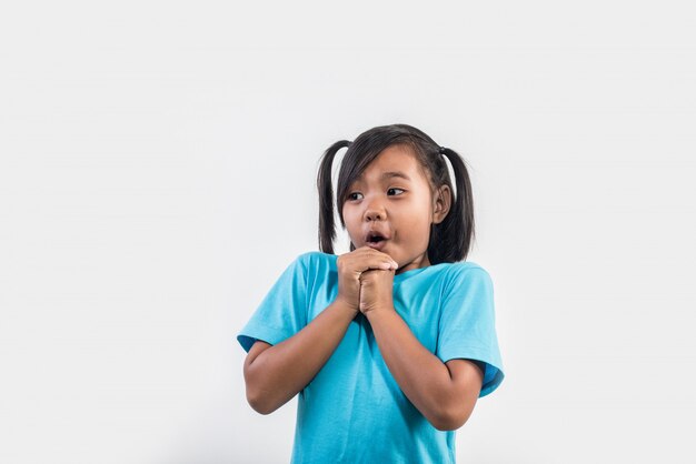 Portrait of Funny little girl acting in studio shot