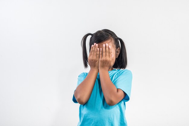 Portrait of Funny little girl acting in studio shot