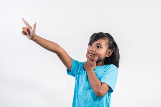 Portrait of Funny little girl acting in studio shot