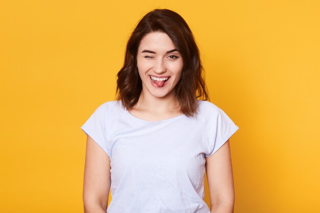 Portrait of funny playful black haired girl looking directly at camera