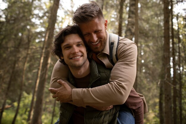 Portrait of gay men hugging outdoors during adventure