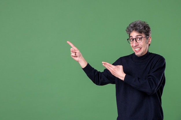 Portrait of genius man dressed casually in studio shot on green wall
