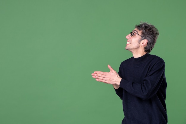 Portrait of genius man dressed casually in studio shot on green wall