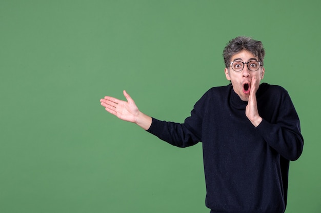 Portrait of genius man dressed casually in studio shot on green wall