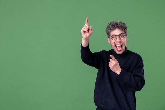 Portrait of genius man in studio shot on green wall