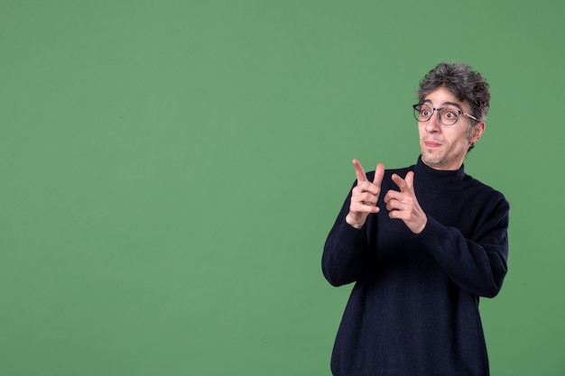 Portrait of genius man in studio shot on green wall