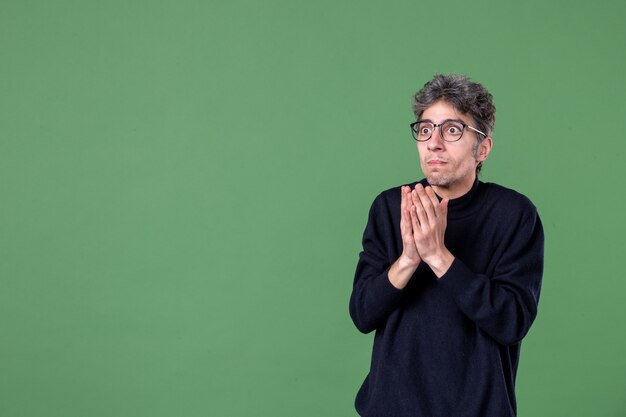 Portrait of genius man in studio shot talking to someone on green surface color male horizontal schools