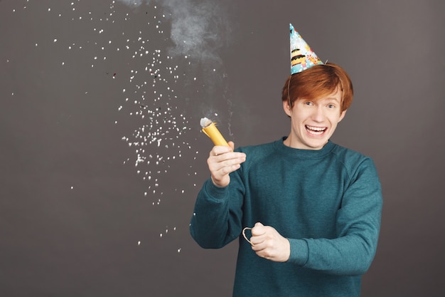 Portrait of ginger boy on spending birthday with friends in warm and happy atmosphere.