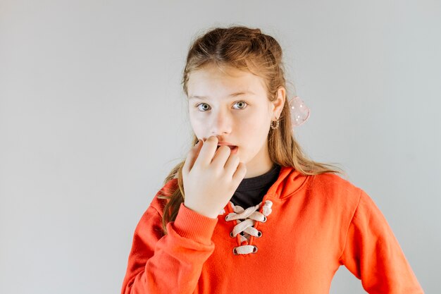 Portrait of a girl biting her fingernails