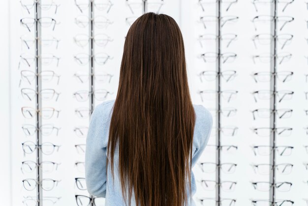 Portrait girl in eyeglasses store choosing pair