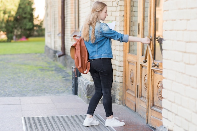 Portrait of girl in front of school