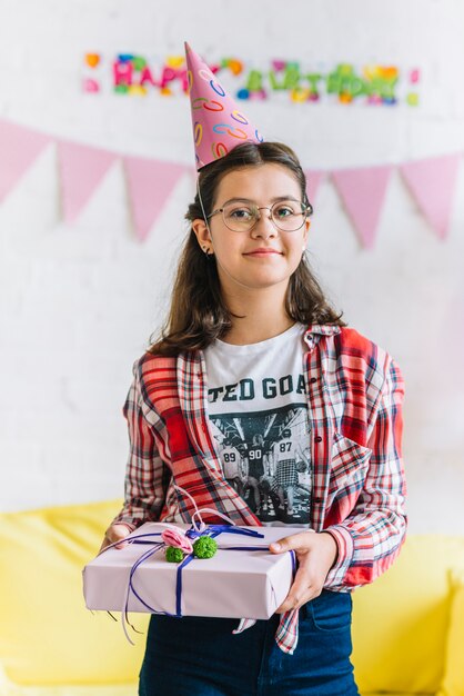 Portrait of a girl holding birthday gift