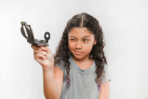 Free photo portrait of a girl holding compass