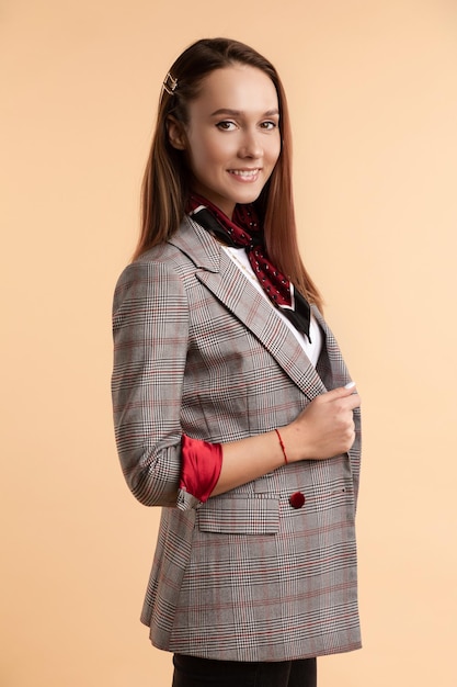 Portrait of girl in jacket and white shirt looking at camera