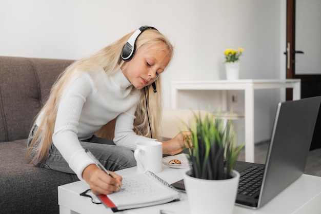 Free photo portrait of a girl paying attention to online class