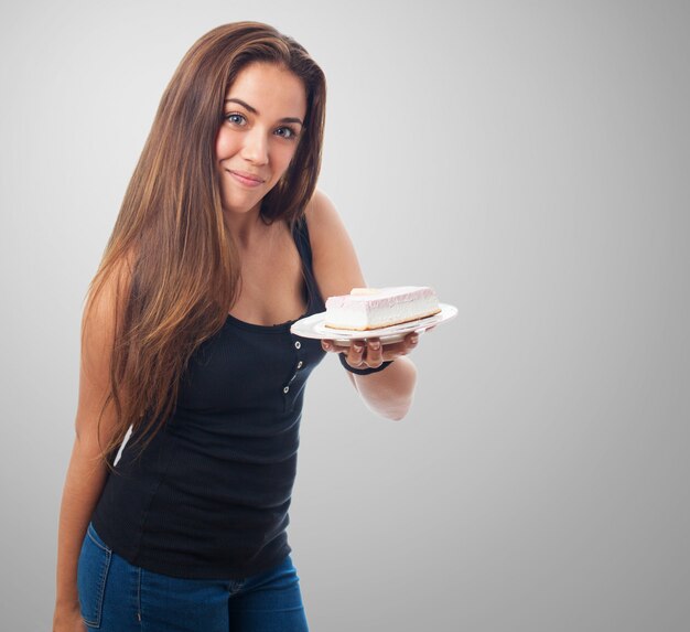 Portrait of girl showing dessert on plate