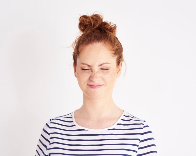 Portrait of girl showing feeling of disgust  shot