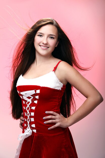 Portrait of a girl smiling wearing a red Christmas dress