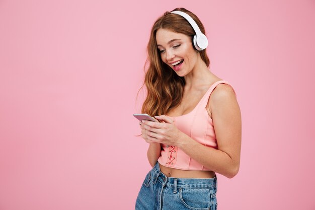 Portrait of a girl in summer clothes listening to music