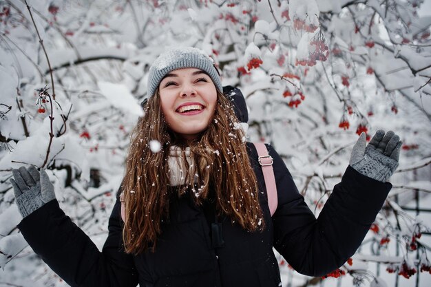 Portrait of girl at winter snowy day near snow covered trees