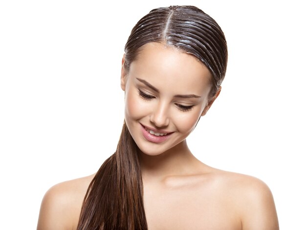 portrait of a girl with applied paint for hairs   on white wall