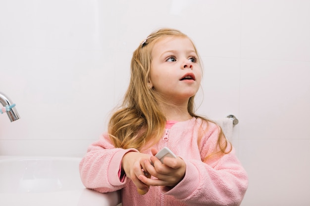 Free photo portrait of a girl with hair comb