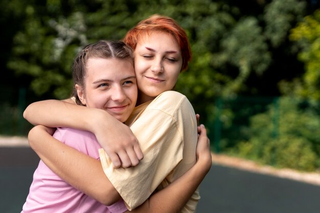 Portrait of girls hugging with copy space