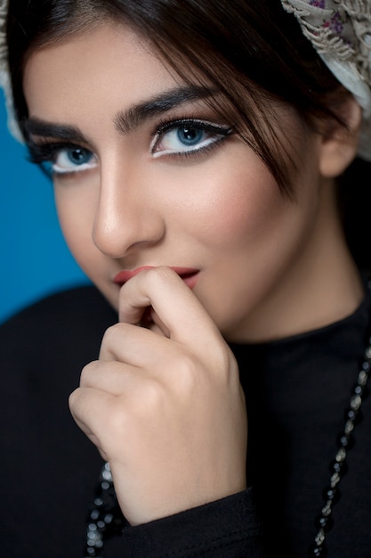 Portrait of a glamorous very beautiful girl brunette with sequins on the face