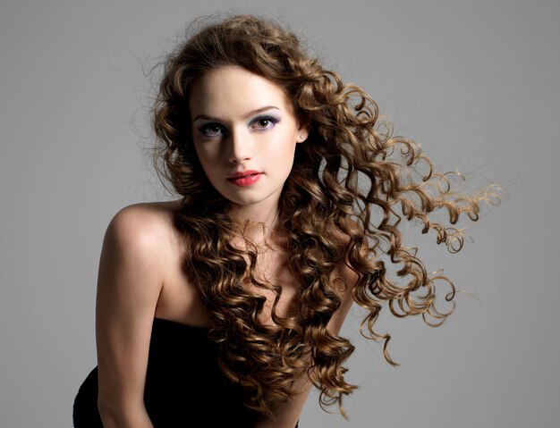 Portrait of glamour beautiful young woman with long curly hair