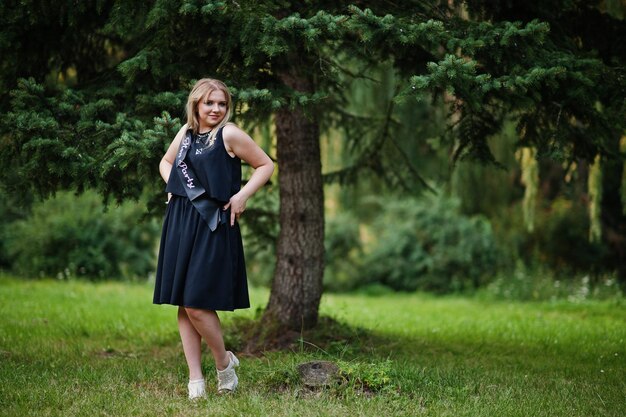 Portrait of gorgeous girl wear on black at hen party posed at park