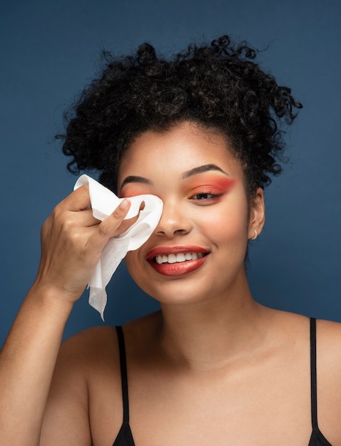 Portrait of a gorgeous woman removing her make-up with a make-up remover tissue