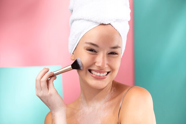 Portrait of a gorgeous woman using a make-up brush