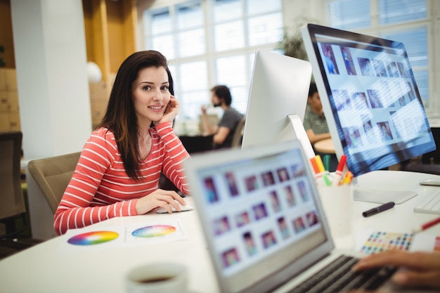 Free photo portrait of graphic designer working at her desk