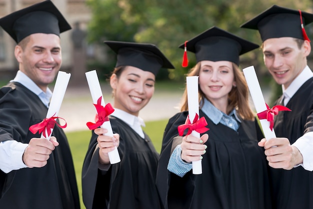 Free photo portrait of group of students celebrating their graduation